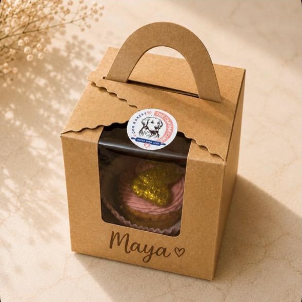 A pupcake in a kraft box with Maya written on the front